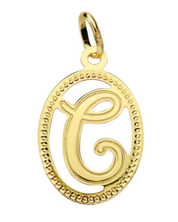 Pendentif ou jeton "Oméga", lettre stylisée ajourée en or jaune 18 carats