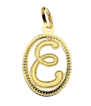 Pendentif ou jeton "Oméga", lettre stylisée ajourée en or jaune 18 carats
