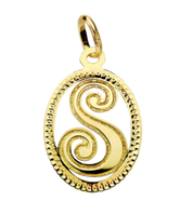 Pendentif ou jeton "Oméga", lettre stylisée ajourée en or jaune 18 carats